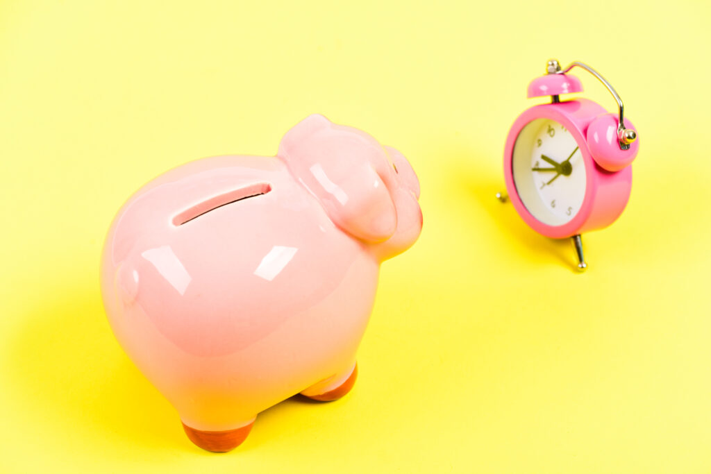 Banking account. Bankruptcy and debt. Pay for debt. Bank collector service. Credit debt. It is time to pay. Piggy bank pink pig and little alarm clock. Financial crisis. Economics and finance.